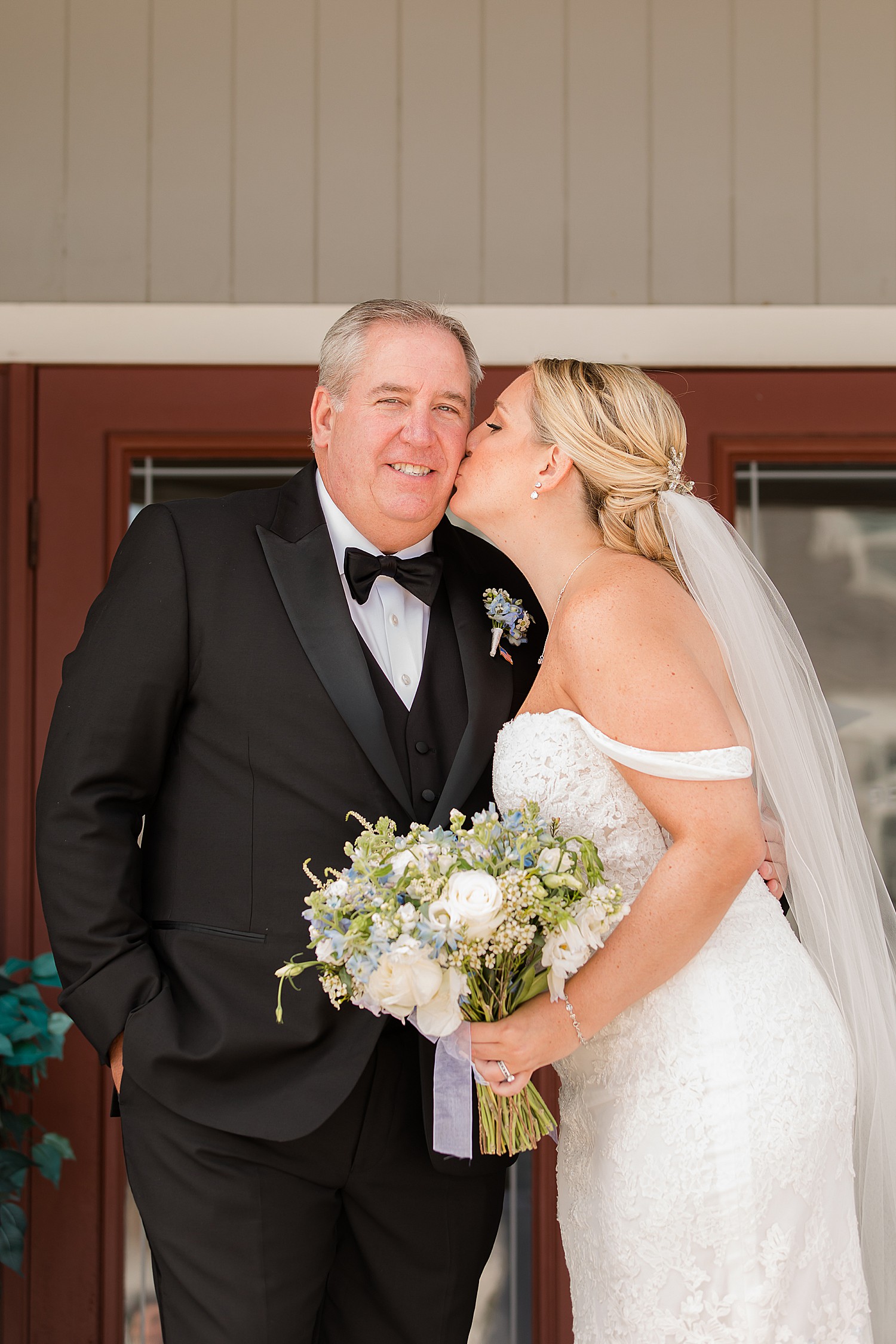 bride kisses her dad on the cheek