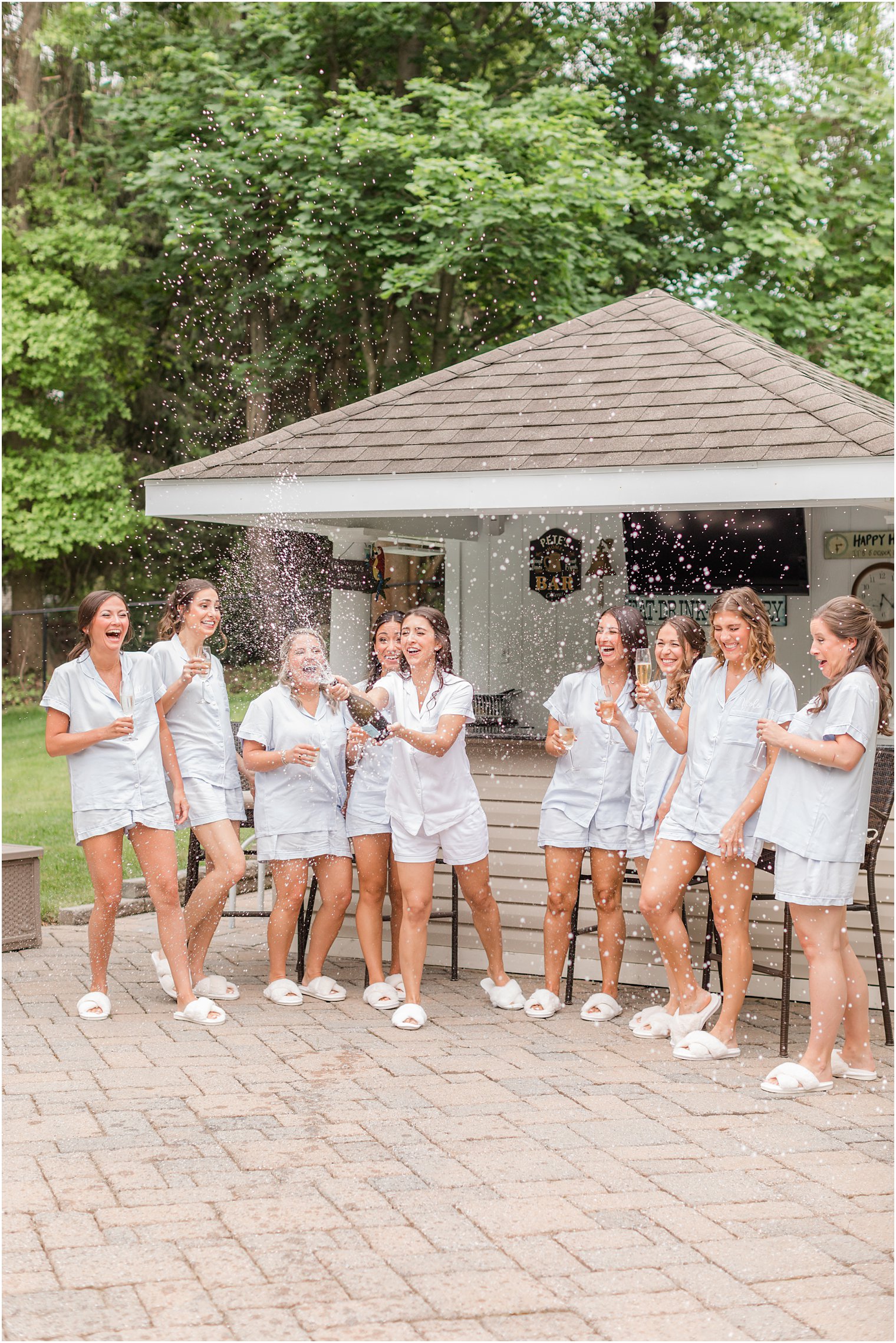 bride pops confetti with bridal party 