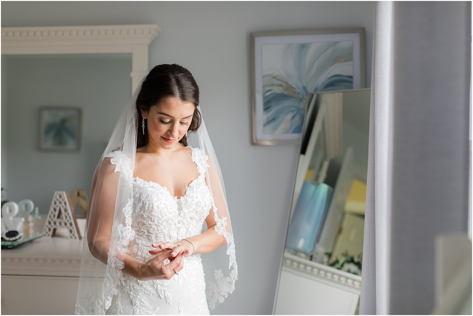 bride looks down at rings before summer wedding at Indian Trail Club