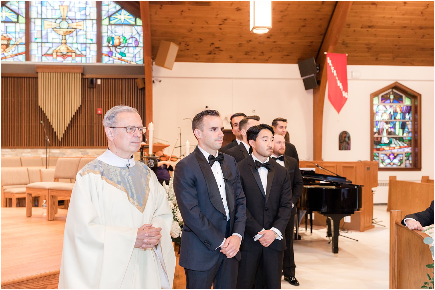 groom watches bride enter traditional church wedding ceremony in New Jersey