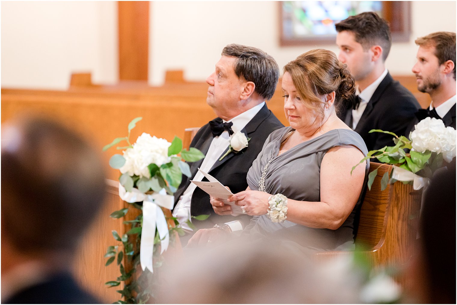 mother reads program during traditional church wedding ceremony in New Jersey