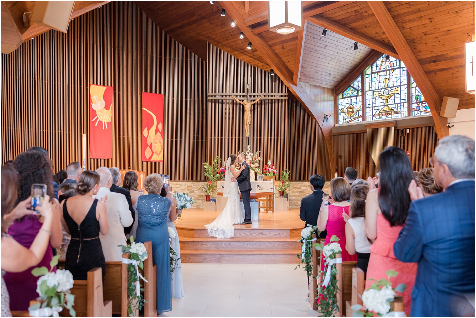 couple kisses during traditional church wedding ceremony in New Jersey