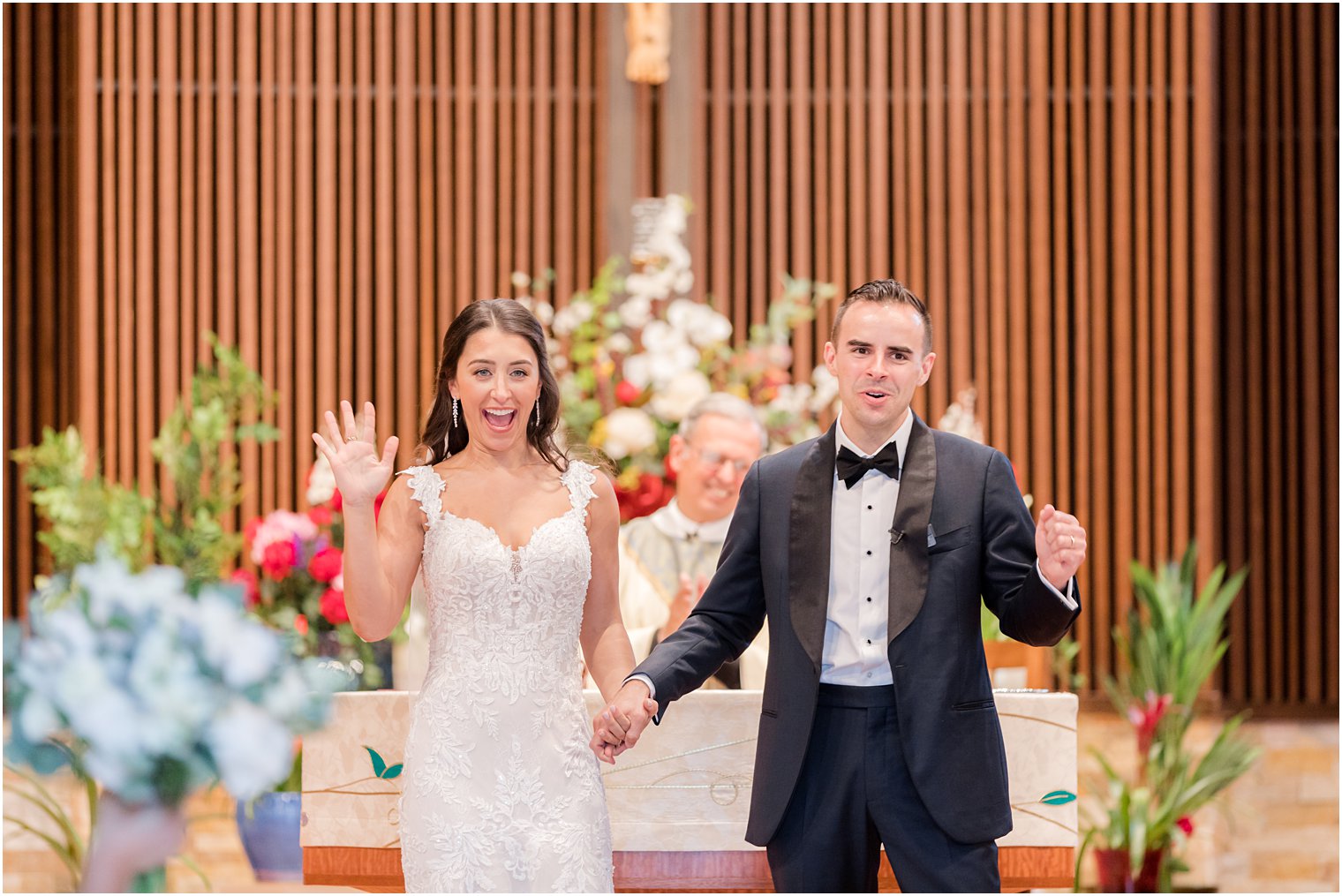 bride and groom cheer leaving traditional church wedding ceremony in New Jersey