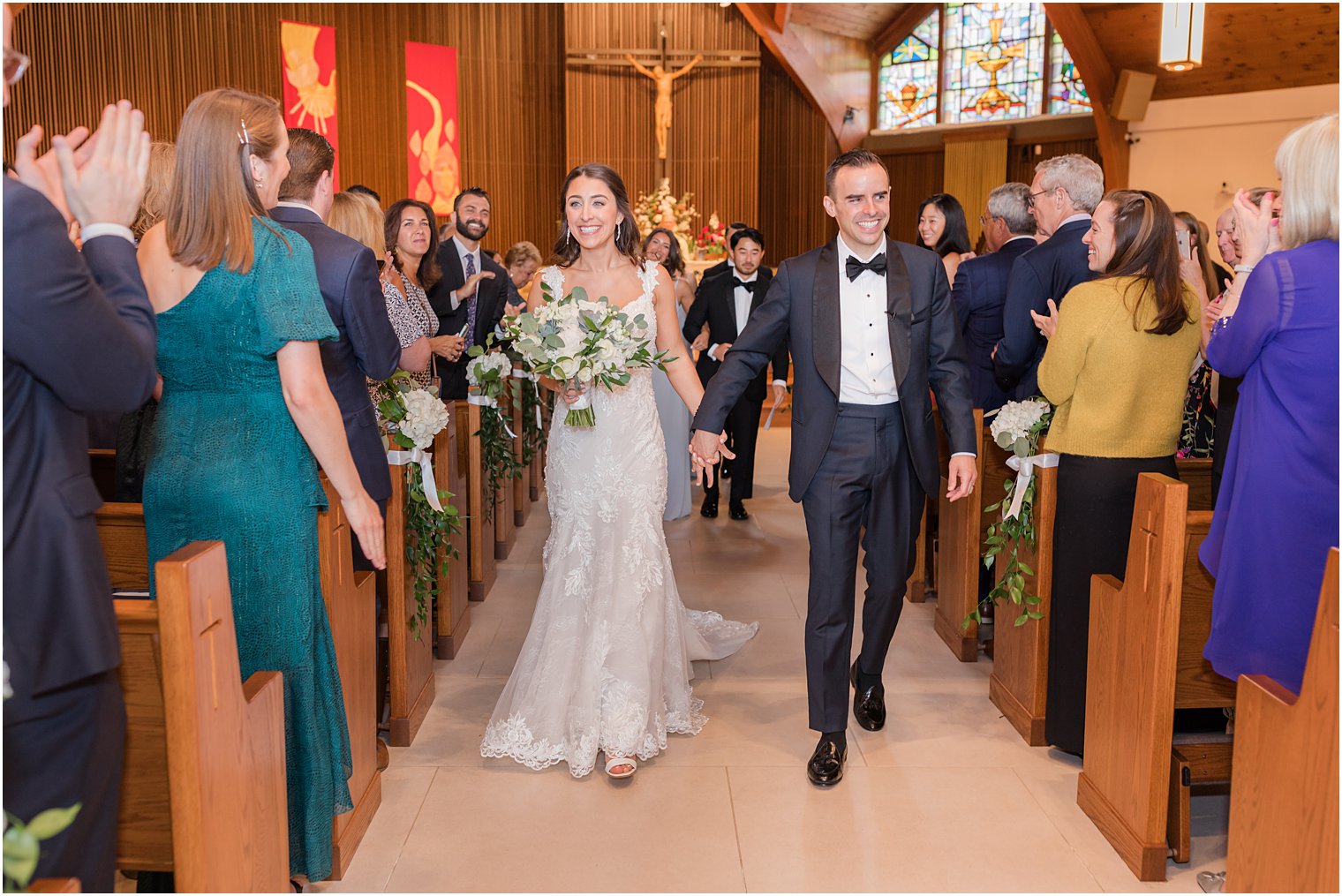 couple walks up aisle after traditional church wedding ceremony in New Jersey