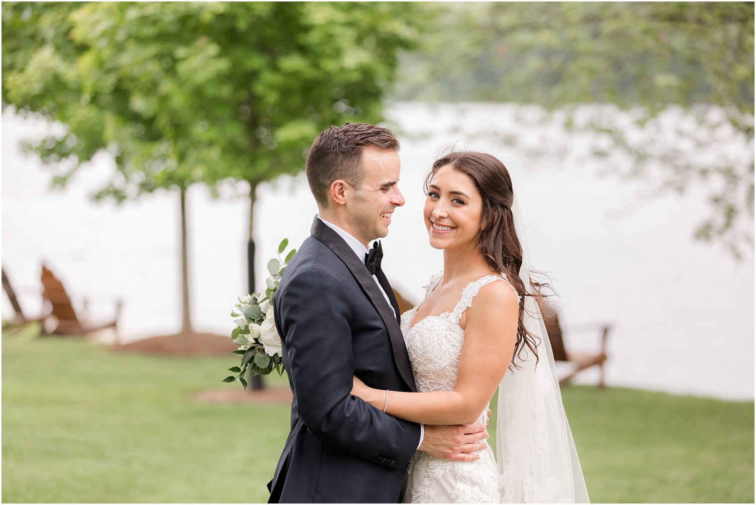 groom smiles looking at bride during wedding portraits at Indian Trail Club