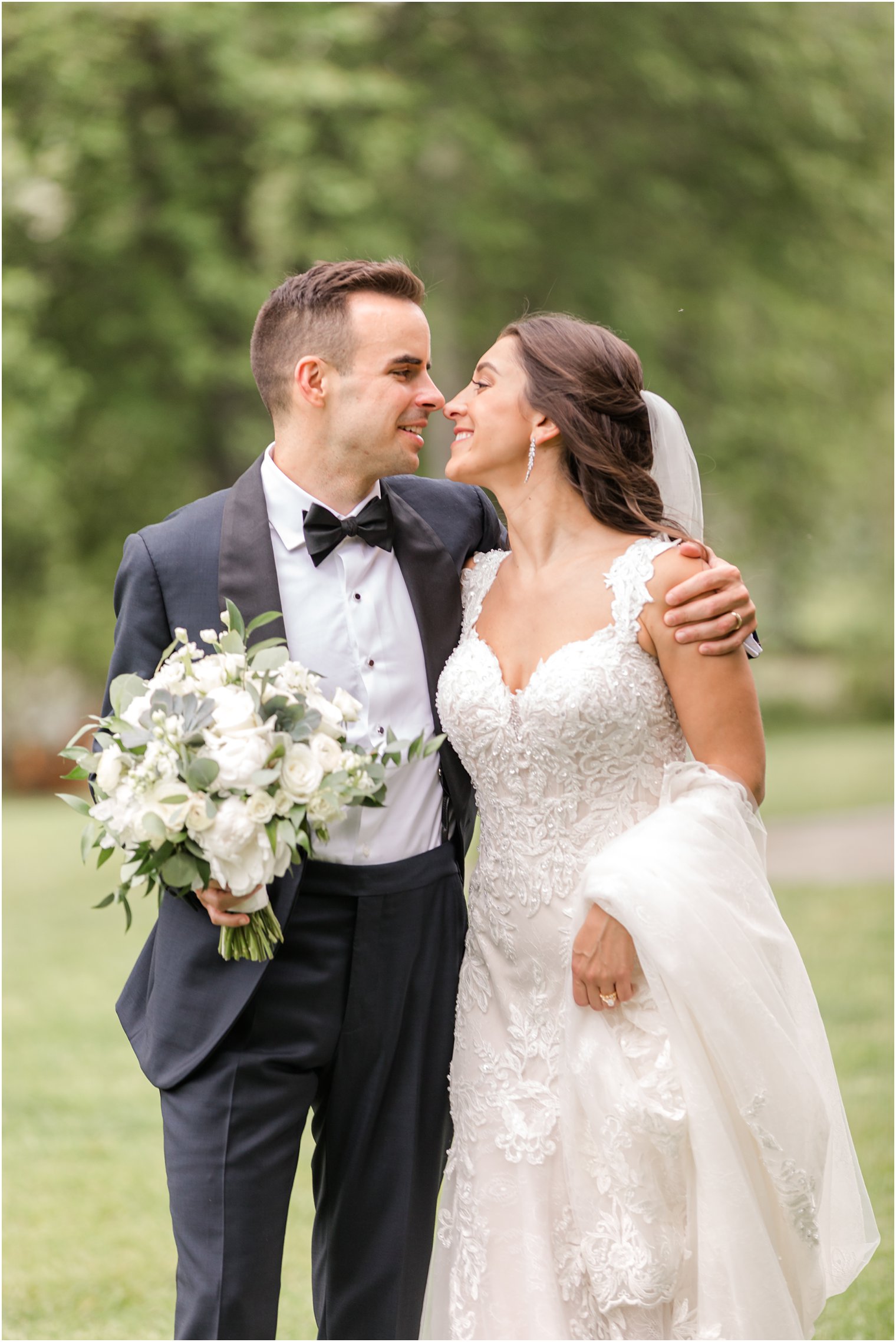 bride and groom lean together laughing during photos at Indian Trail Club