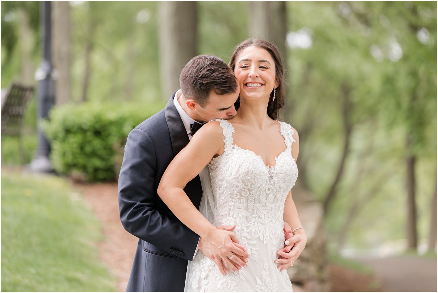 groom kisses bride's shoulder during NJ wedding photos