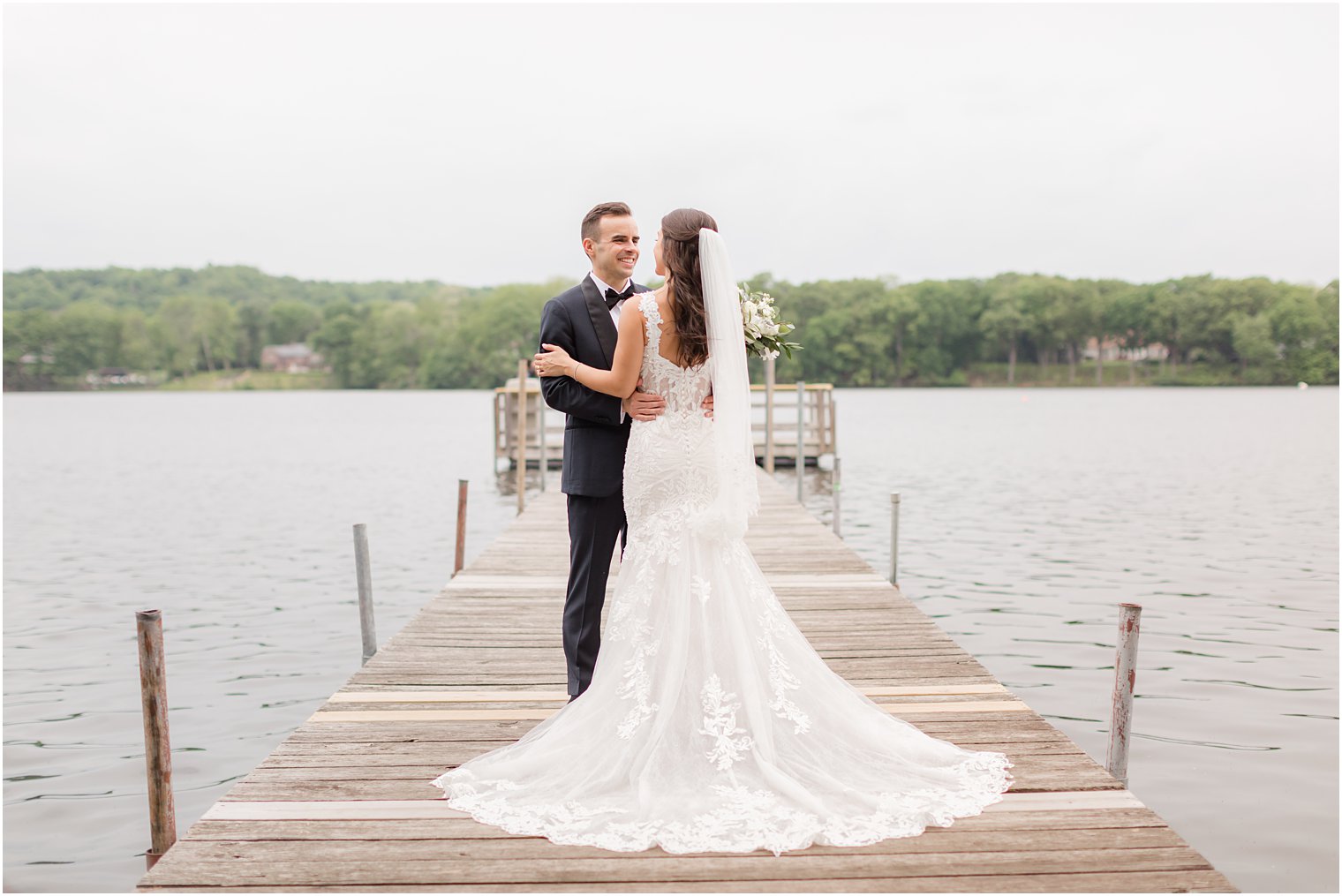 bride and groom stand on dock at Indian Trail Club