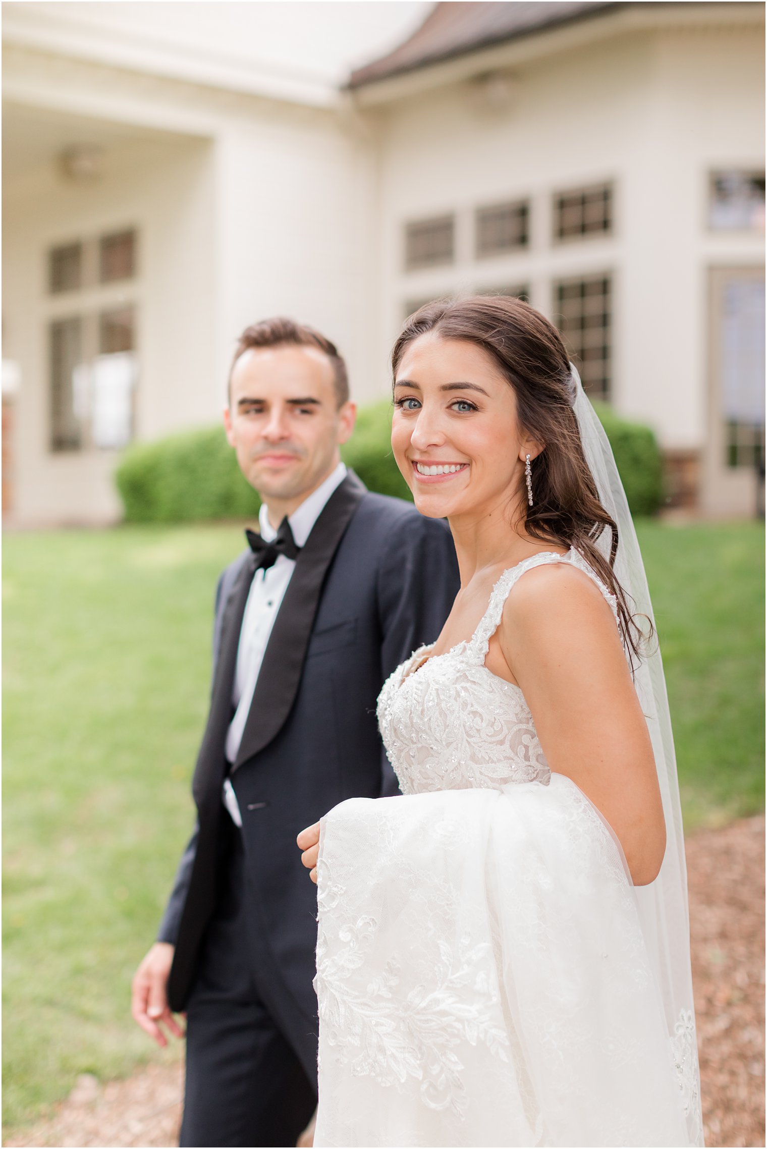newlyweds walk by Indian Trail Club during photos