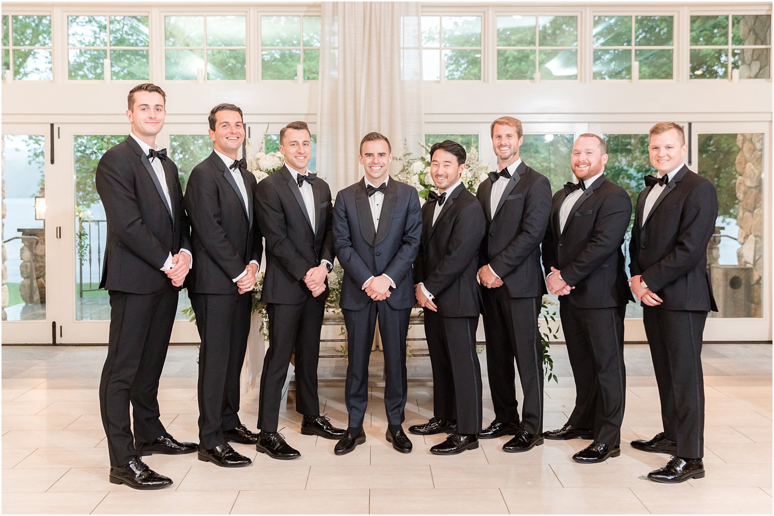 groom and groomsmen pose together inside Indian Trail Club