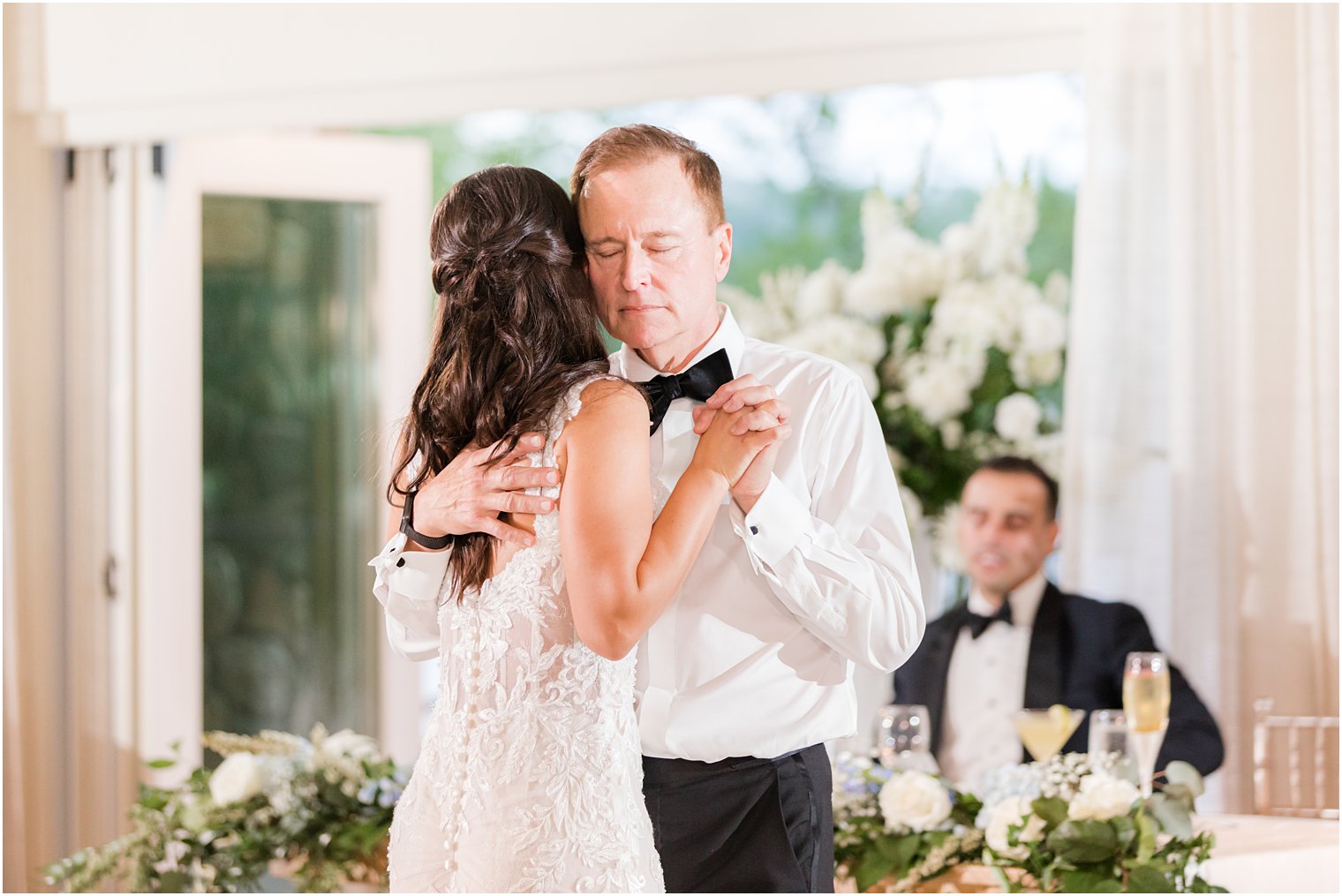 dad hugs bride on dance floor during NJ wedding reception