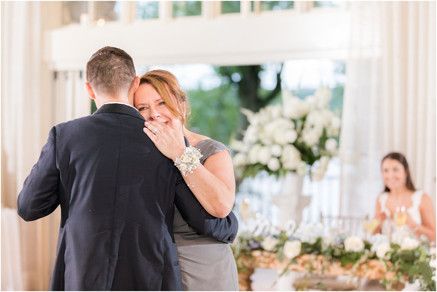 mom hugs groom during NJ wedding reception