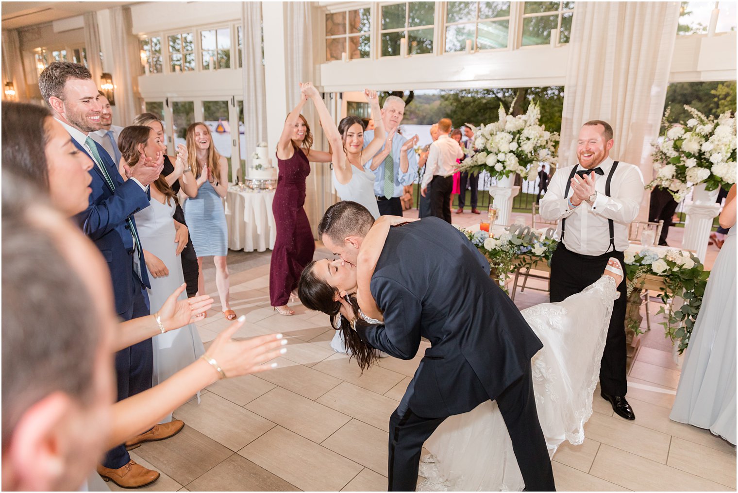 groom dips bride kissing her during NJ wedding reception dance floor