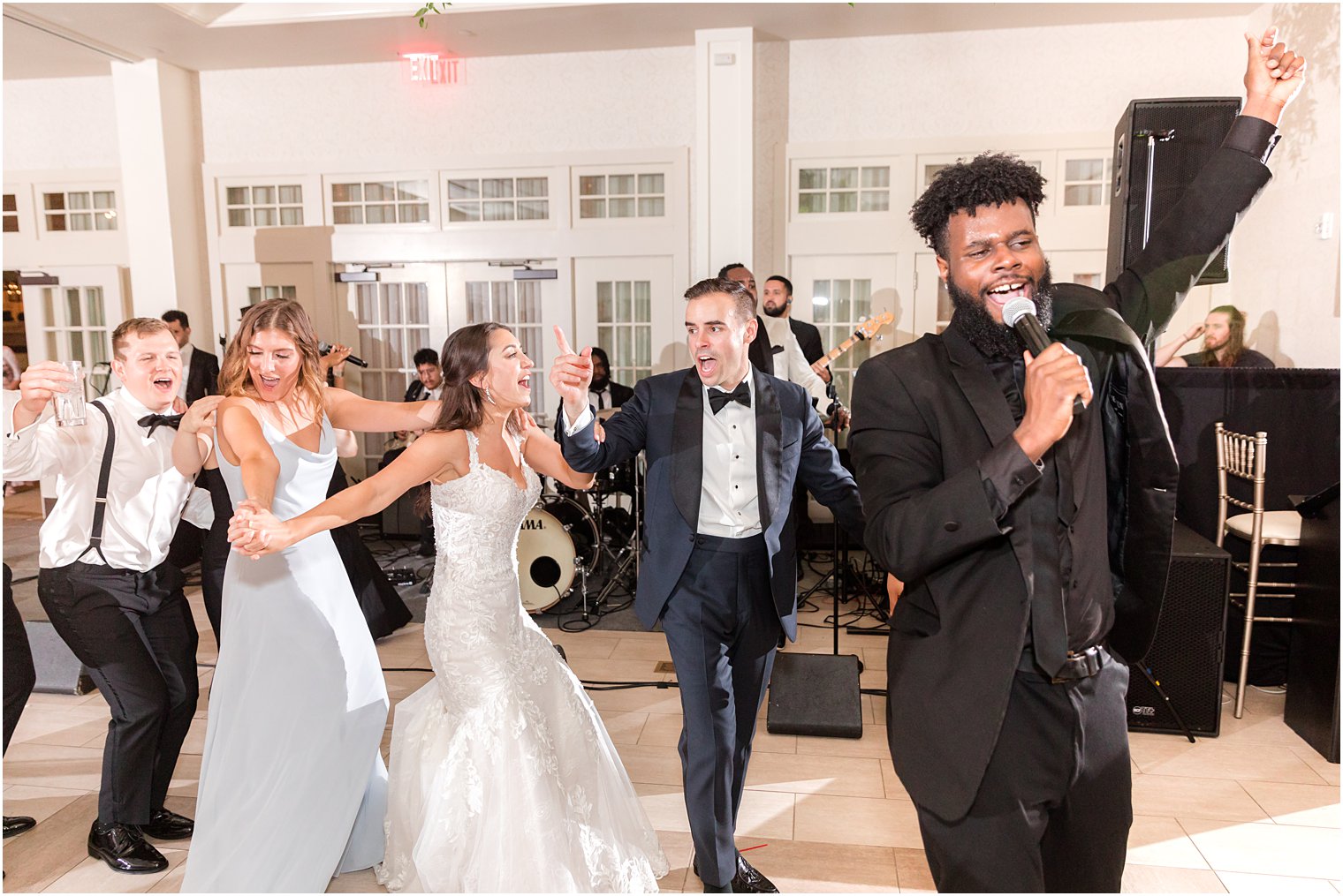 bride and groom dance with band and guests during NJ wedding reception