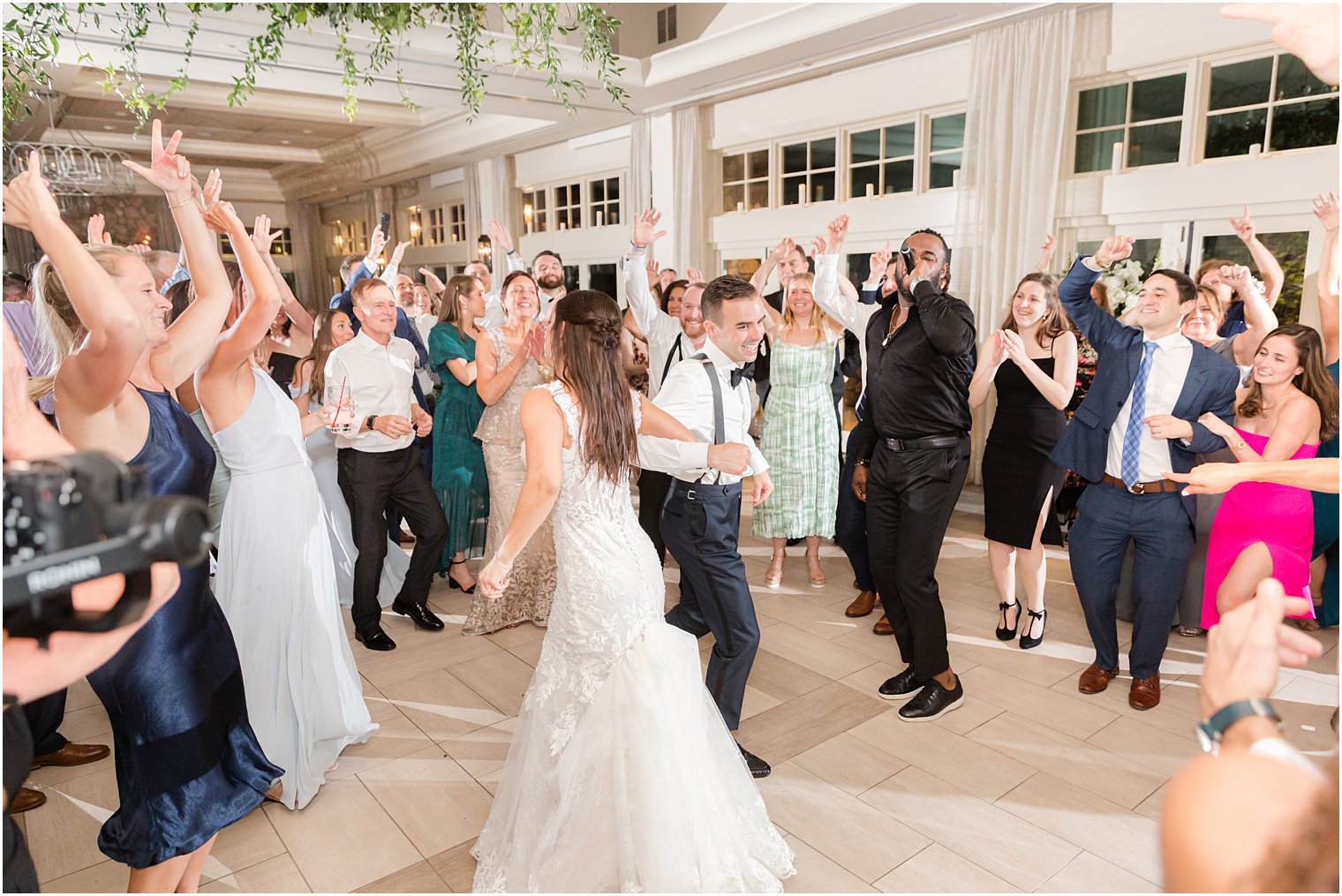 bride and groom dance with guests during NJ wedding reception