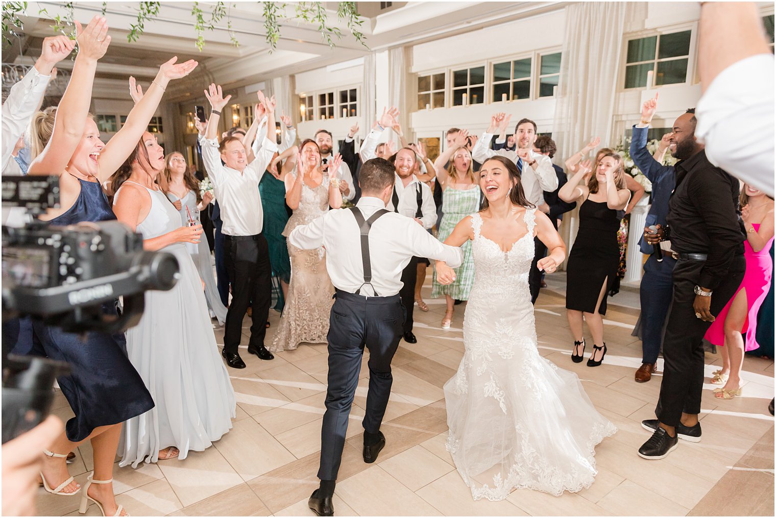 newlyweds dance with guests during NJ wedding reception