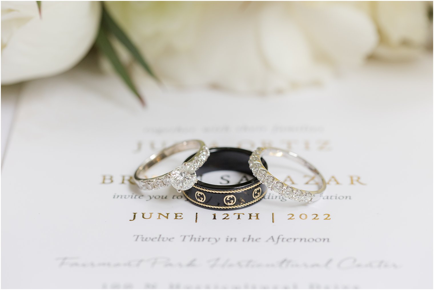 wedding bands rest on invitation suite from Truly Engaging 