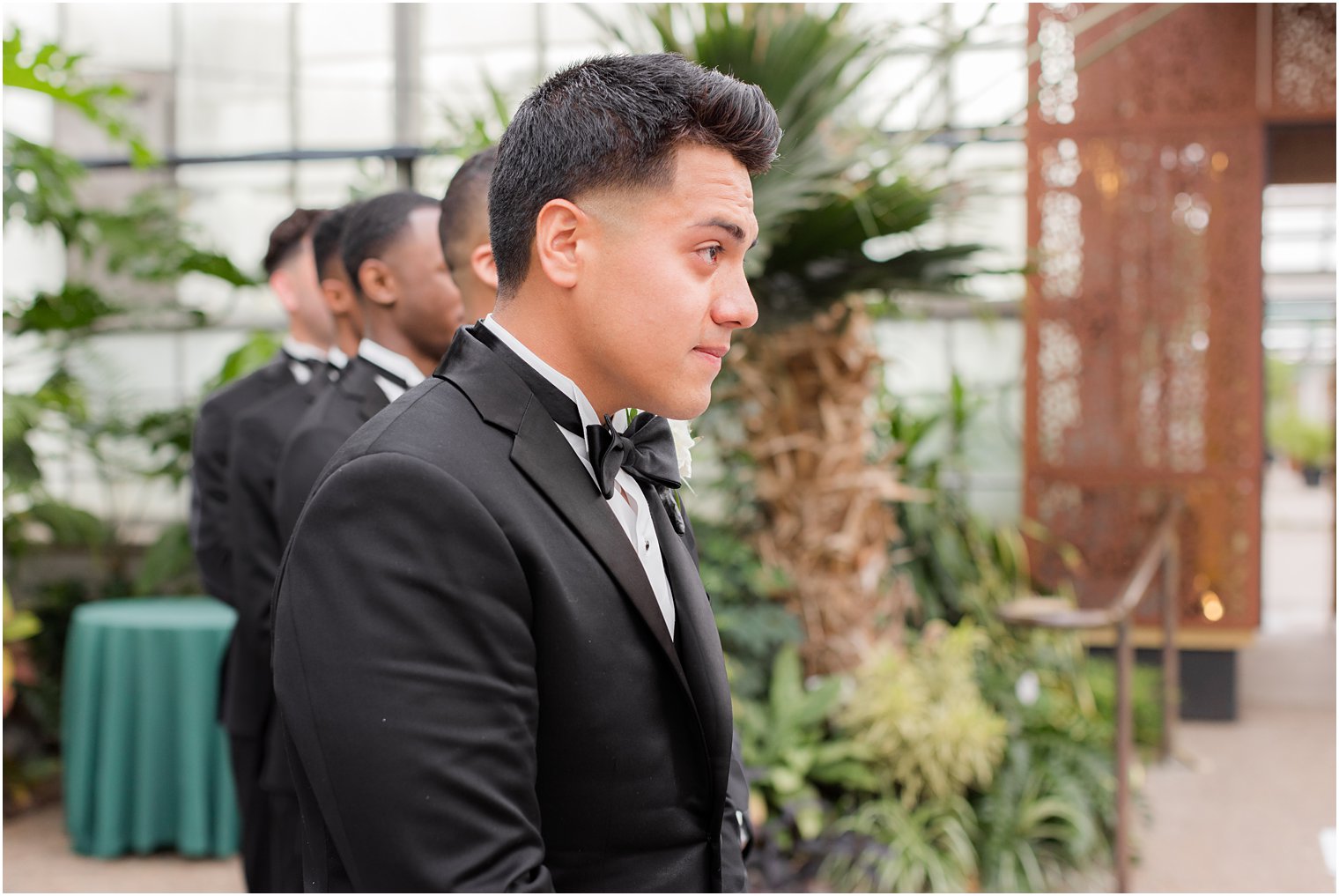 groom watches bride walk down aisle