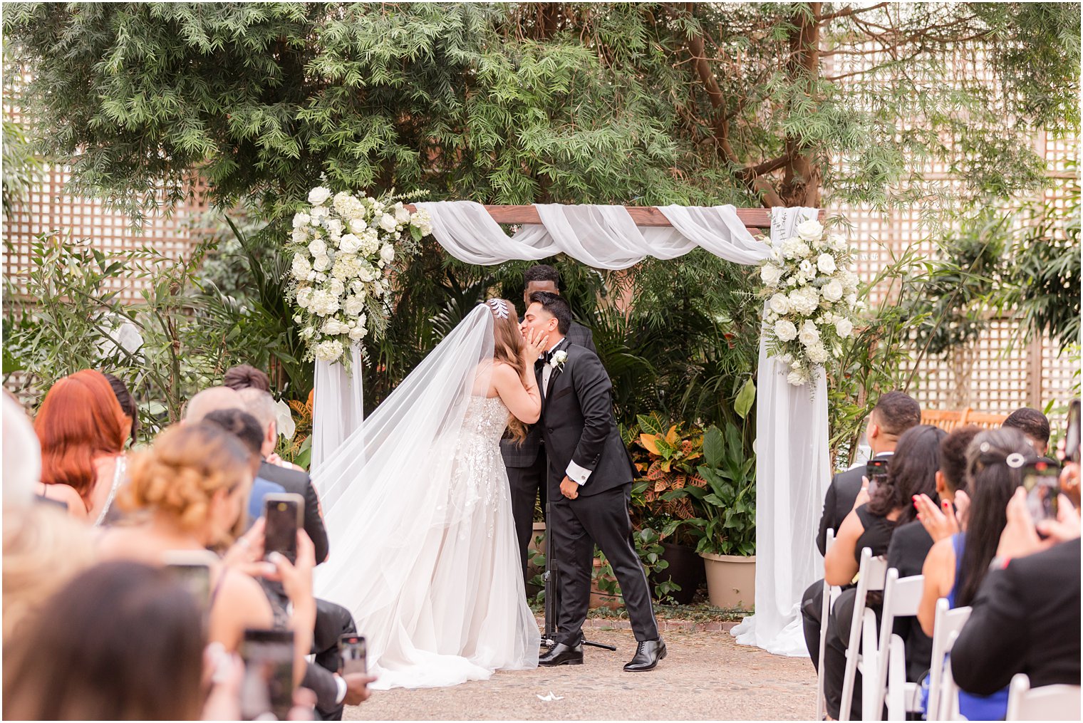 bride and groom kiss after Fairmont Park Horticulture Center wedding ceremony