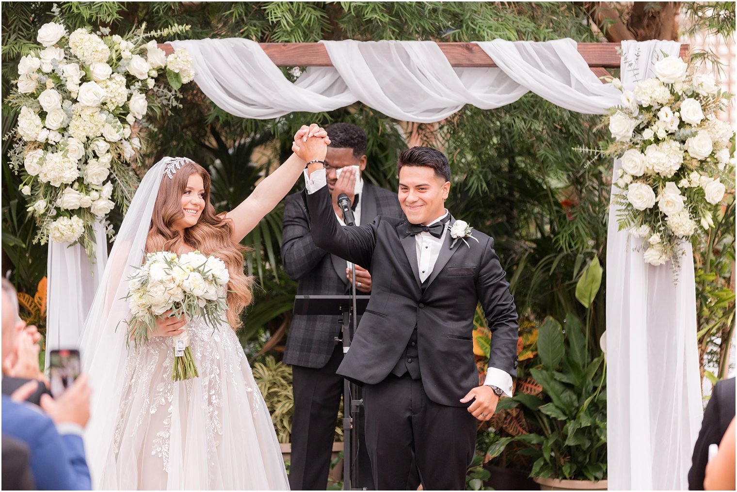 bride and groom cheer after Fairmont Park Horticulture Center wedding ceremony