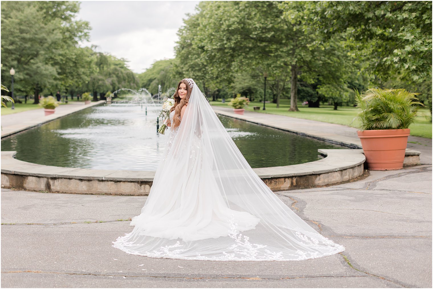 bride stands by fountain in Fairmount Park Horticulture Center