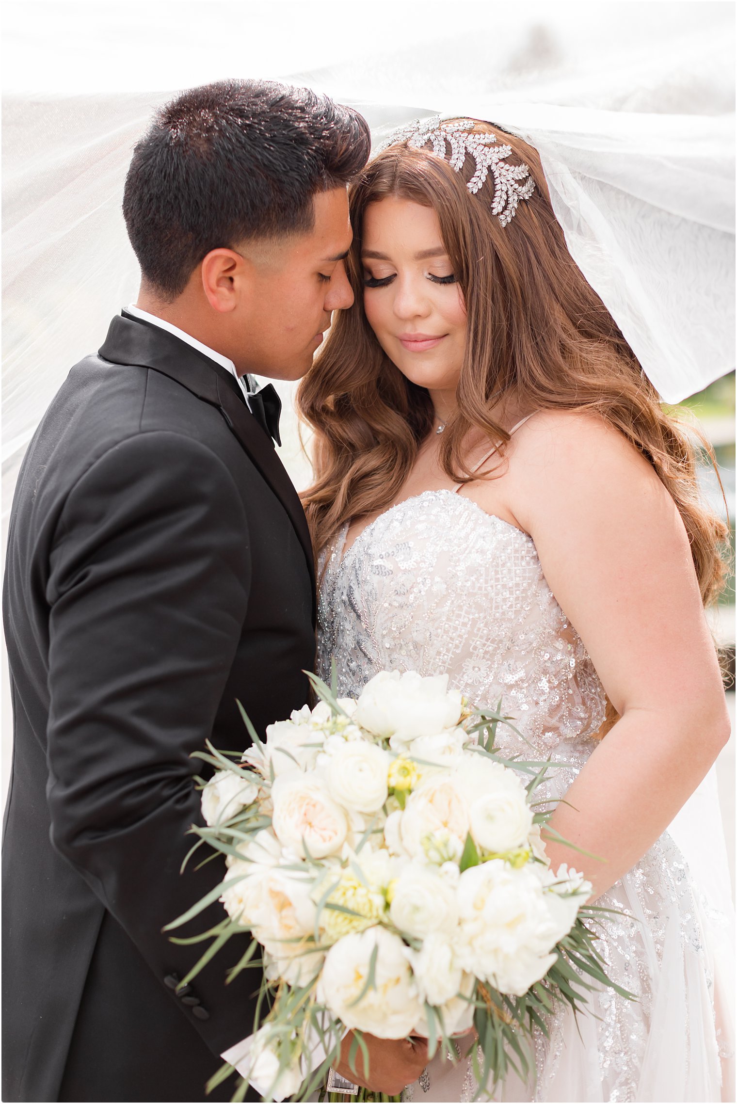 groom leans into bride's cheek at Fairmount Park Horticulture Center