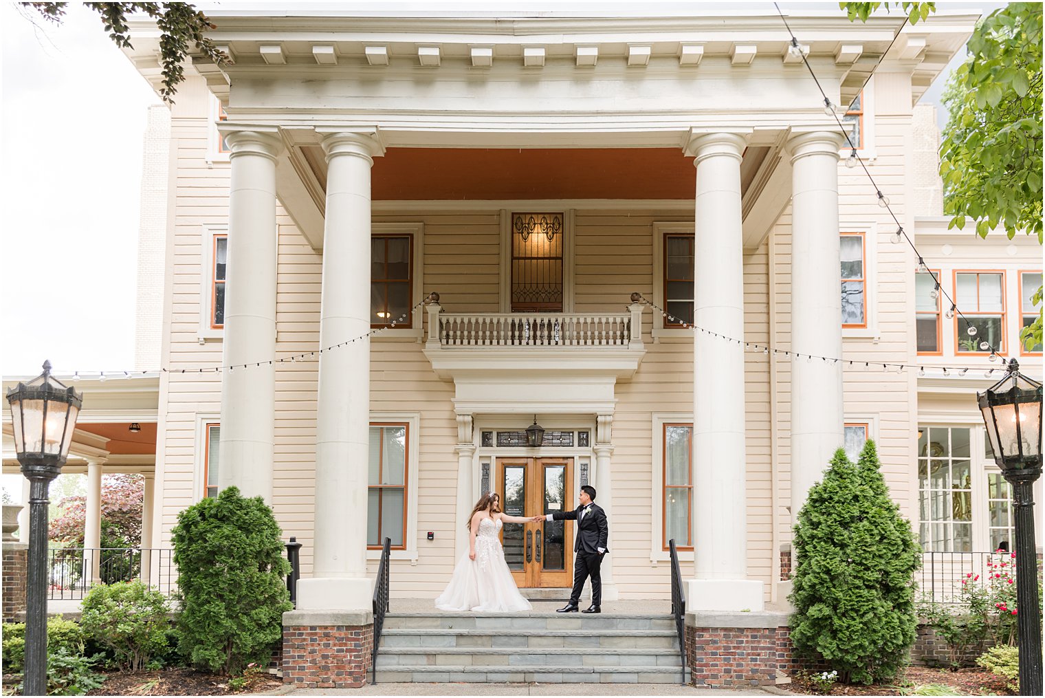 newlyweds pose on staircase at Collingswood Grand Ballroom 