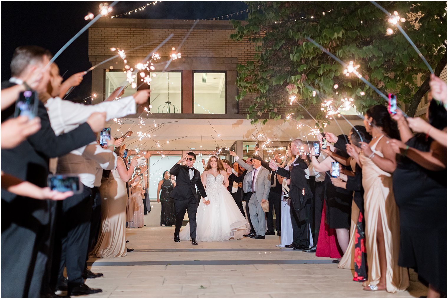 bride and groom walk under sparklers at Collingswood Grand Ballroom