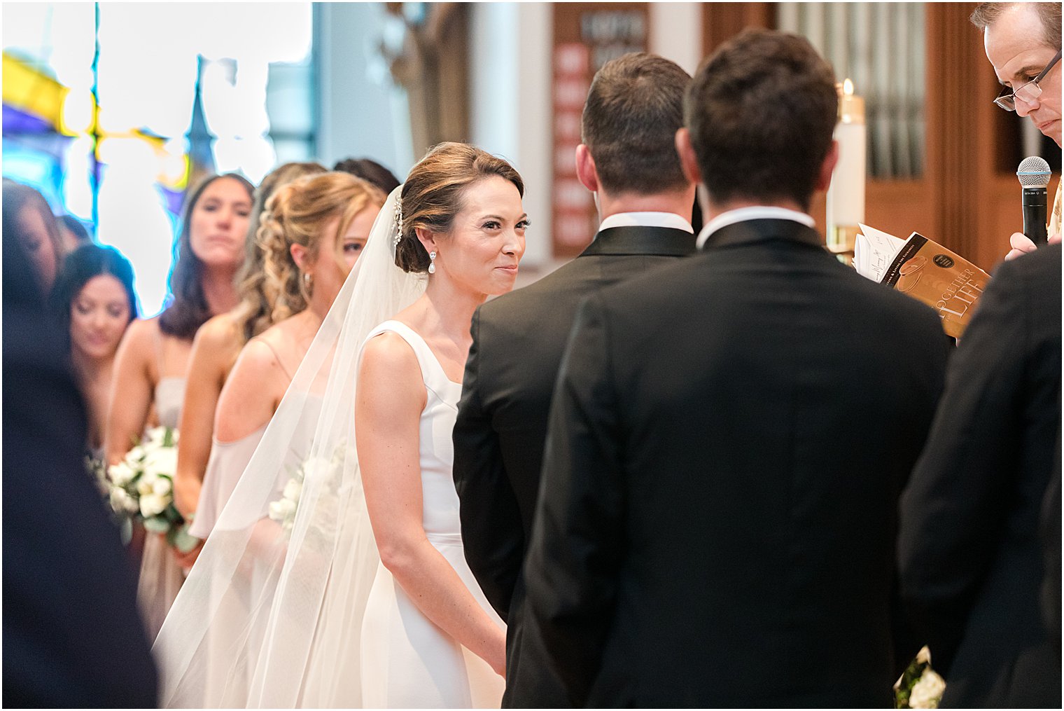 bride looks at groom during traditional ceremony at