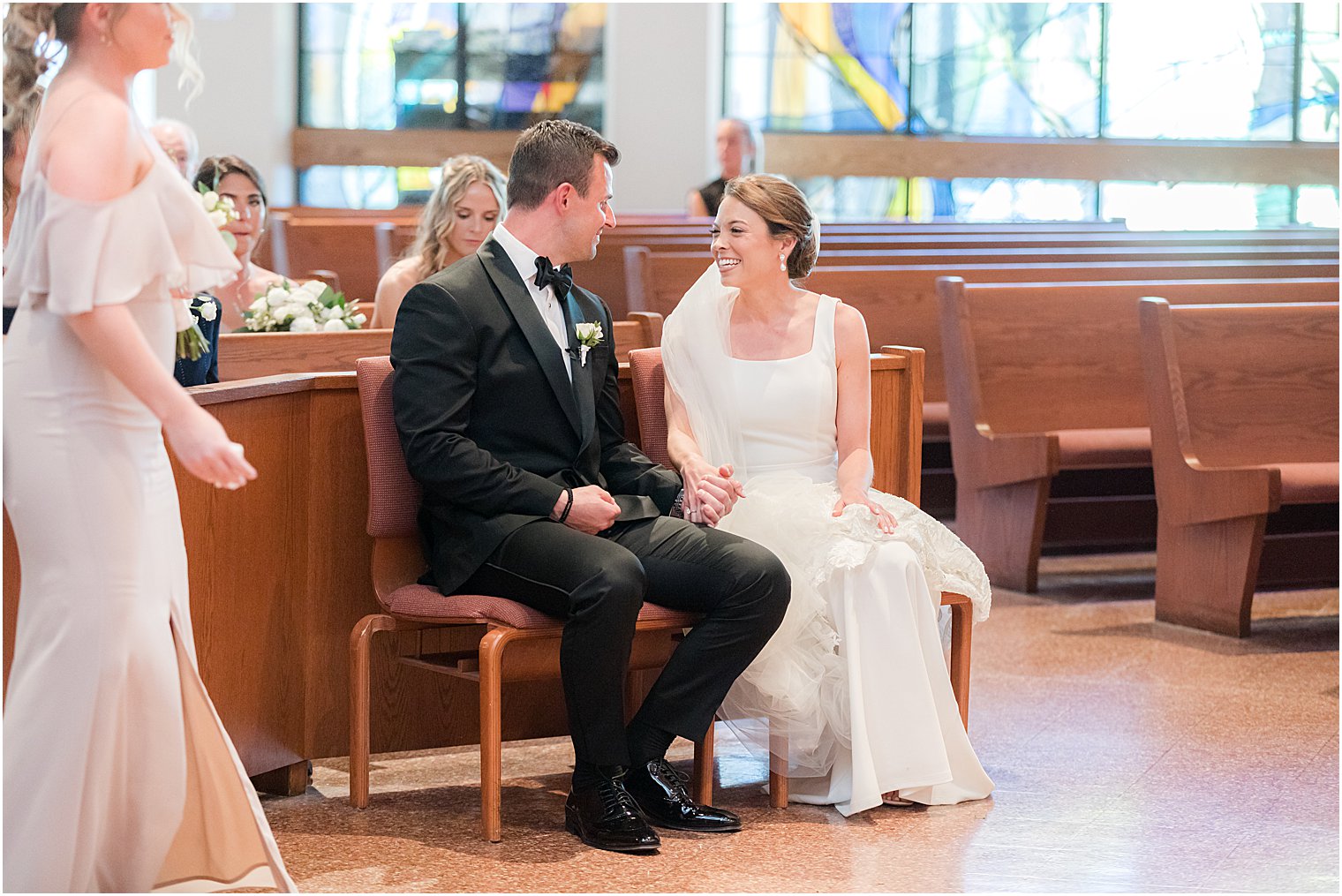 bride and groom look at each other during traditional ceremony at St.Joseph Roman Catholic Church