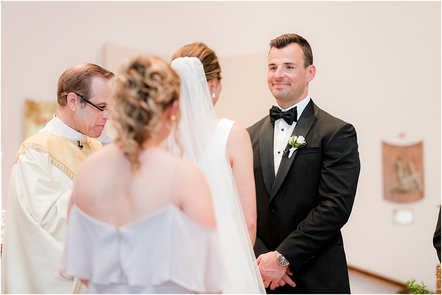couple exchanges vows during traditional ceremony at St.Joseph Roman Catholic Church