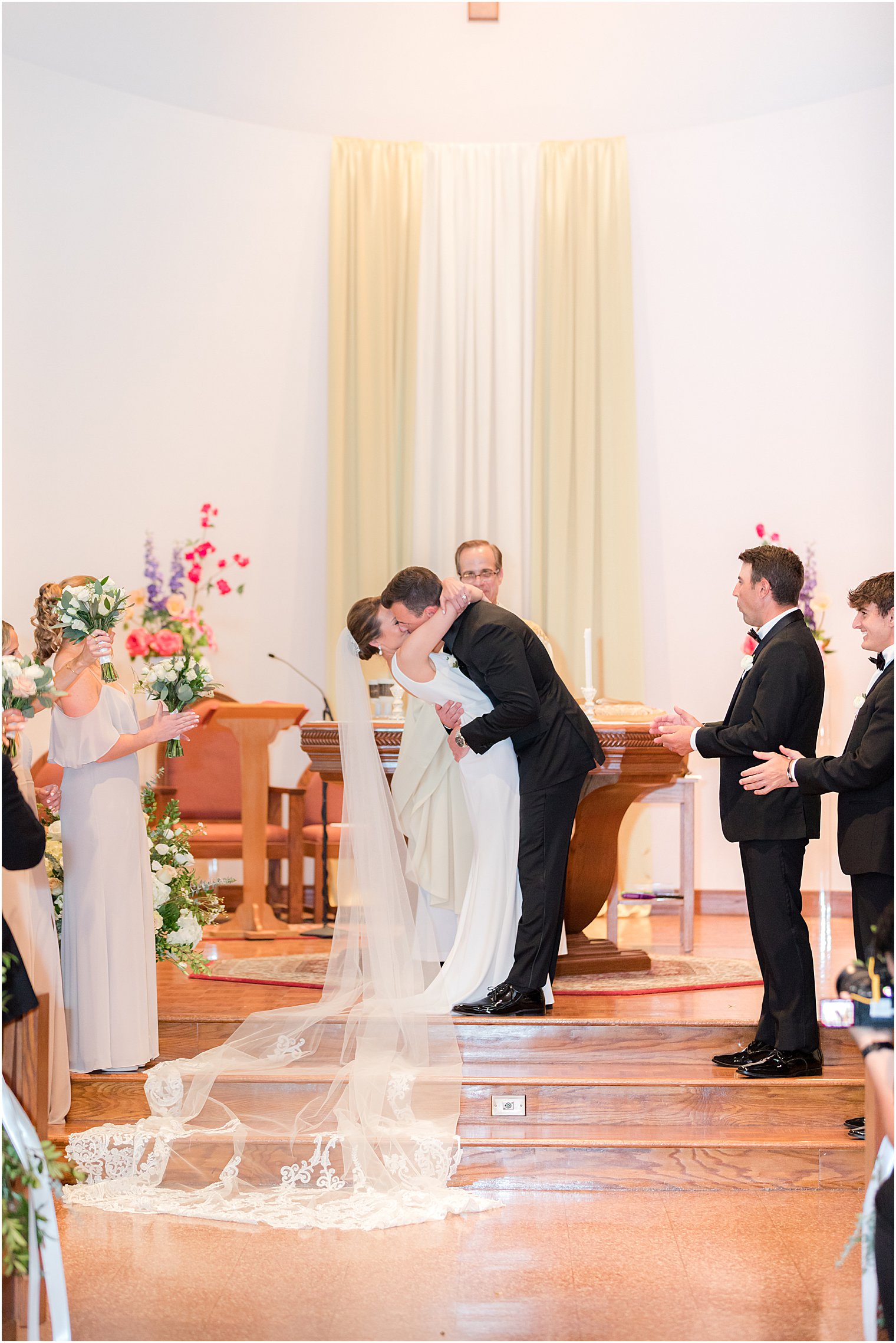 couple kisses during traditional ceremony at St.Joseph Roman Catholic Church