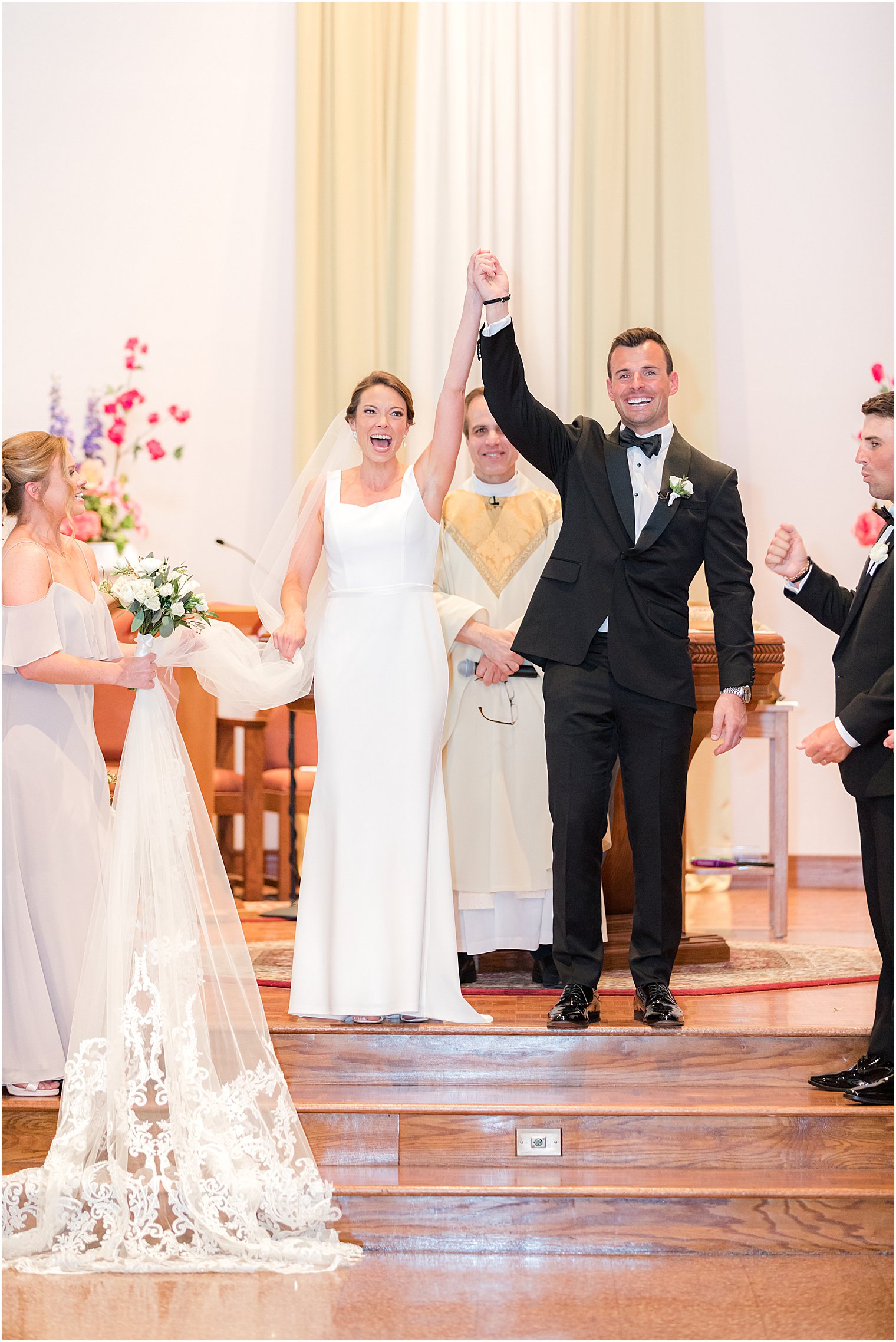 bride and groom cheer leaving traditional ceremony at St.Joseph Roman Catholic Church