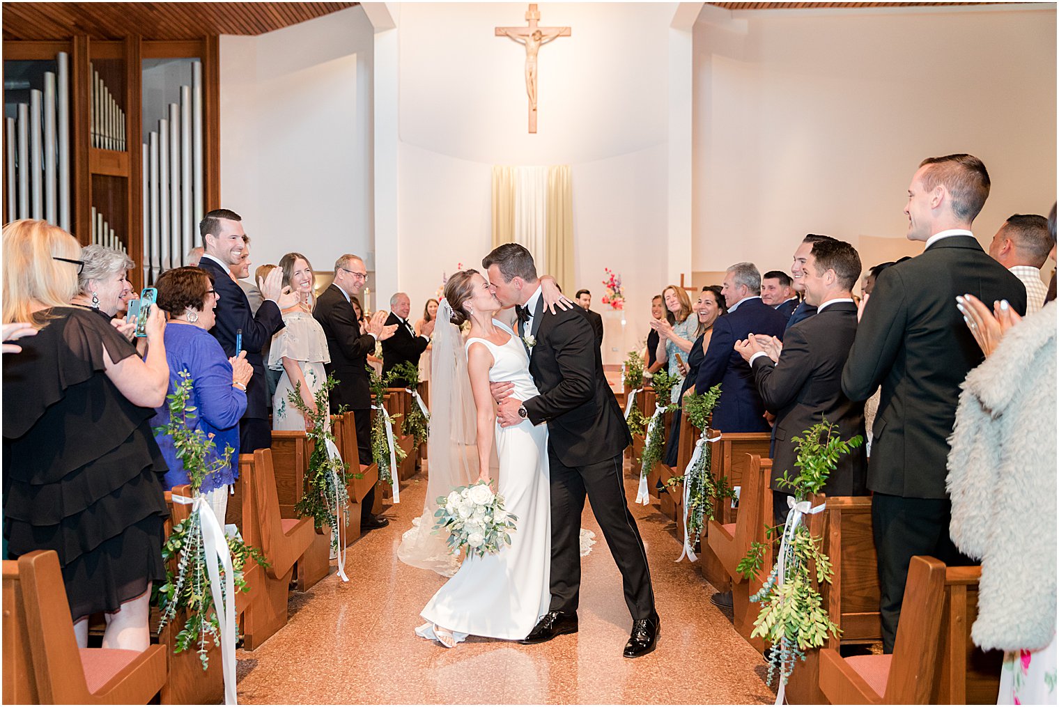 bride and groom kiss up aisle in New Jersey 