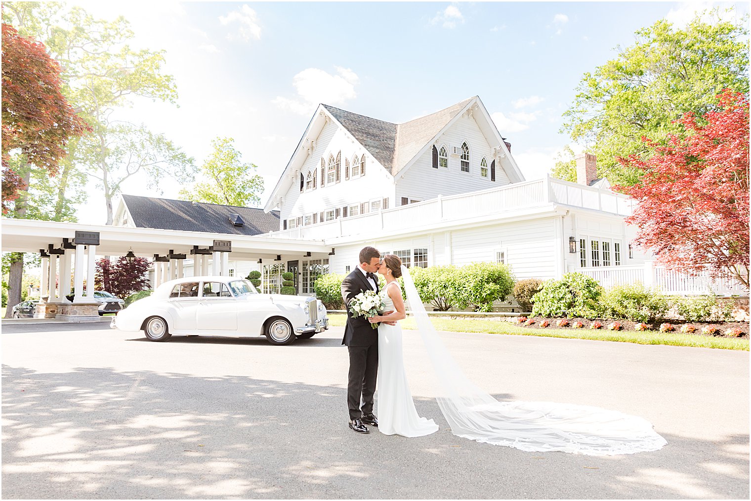 couple poses outside Ryland Inn during spring wedding photos