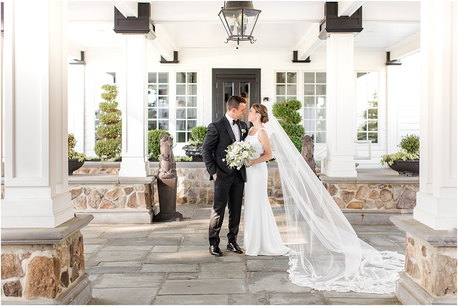 bride and groom kiss under awning at Ryland Inn