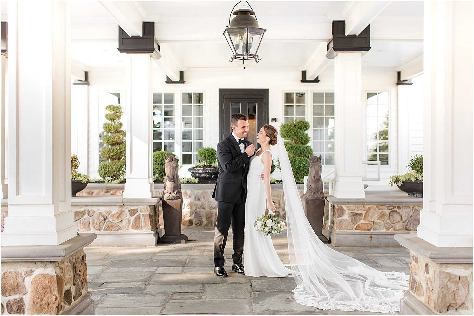 bride and groom kiss under awning at Ryland Inn