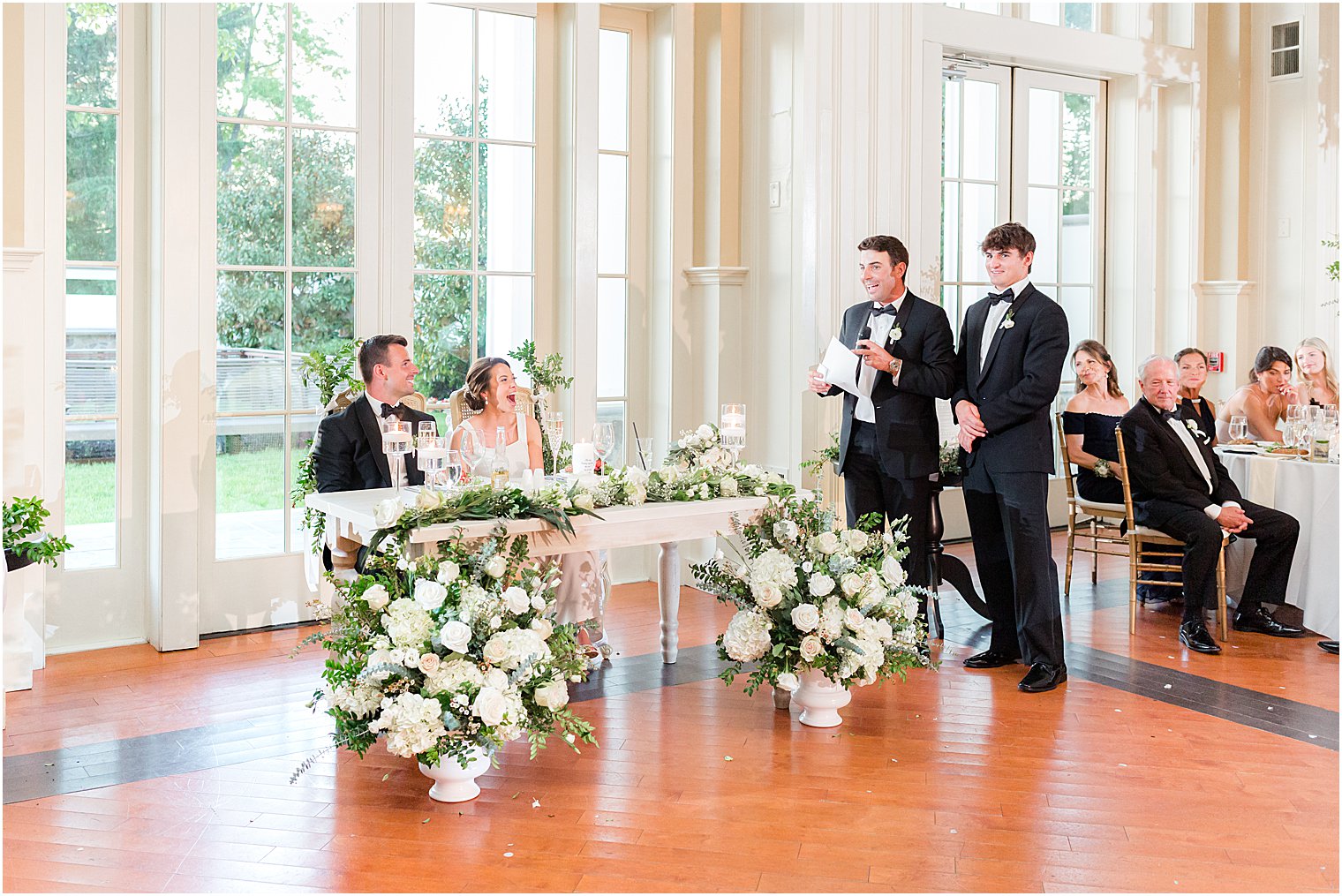 groomsmen give speech by sweetheart table at Whitehouse Station NJ wedding reception
