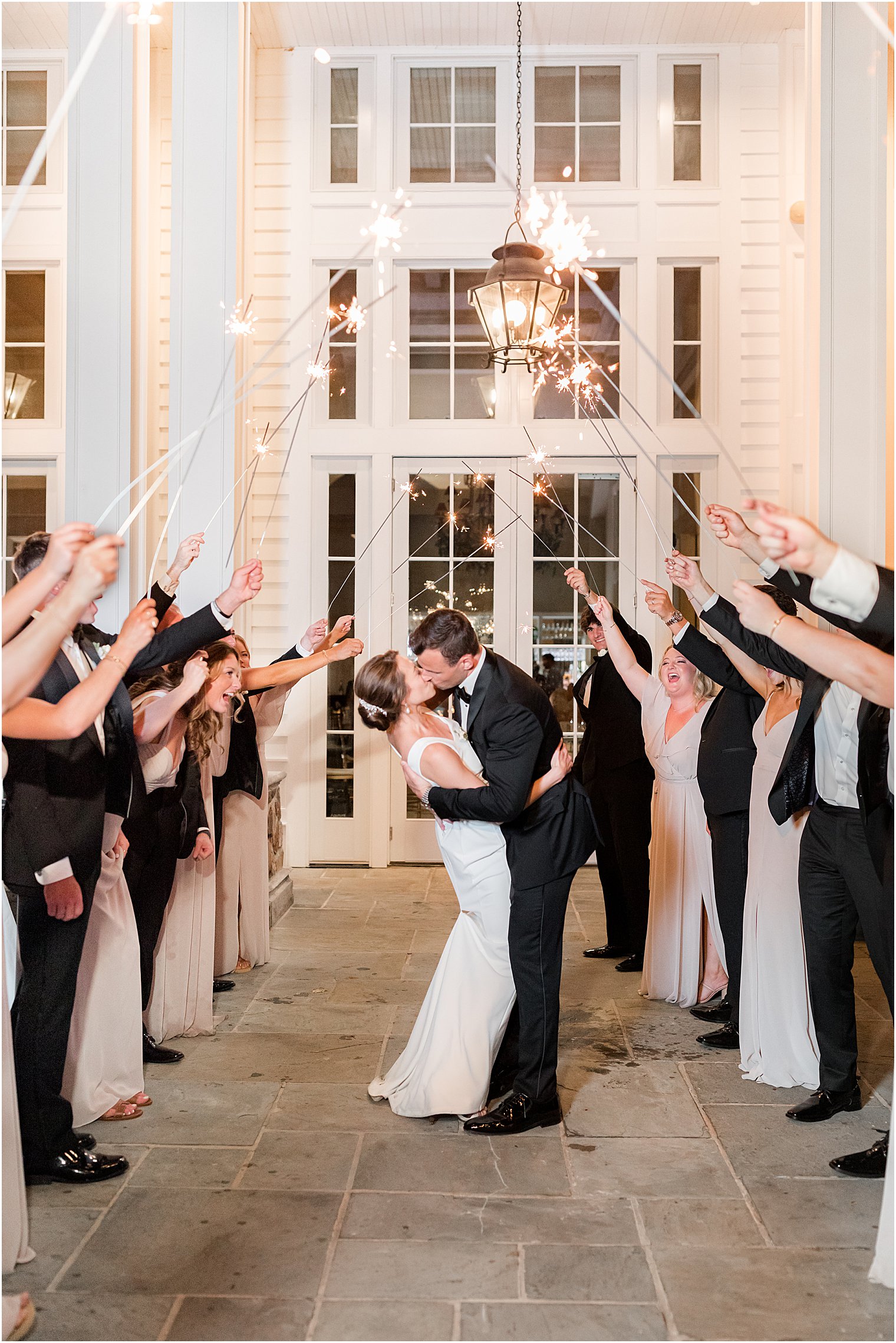 bride and groom kiss during sparkler exit at Ryland Inn