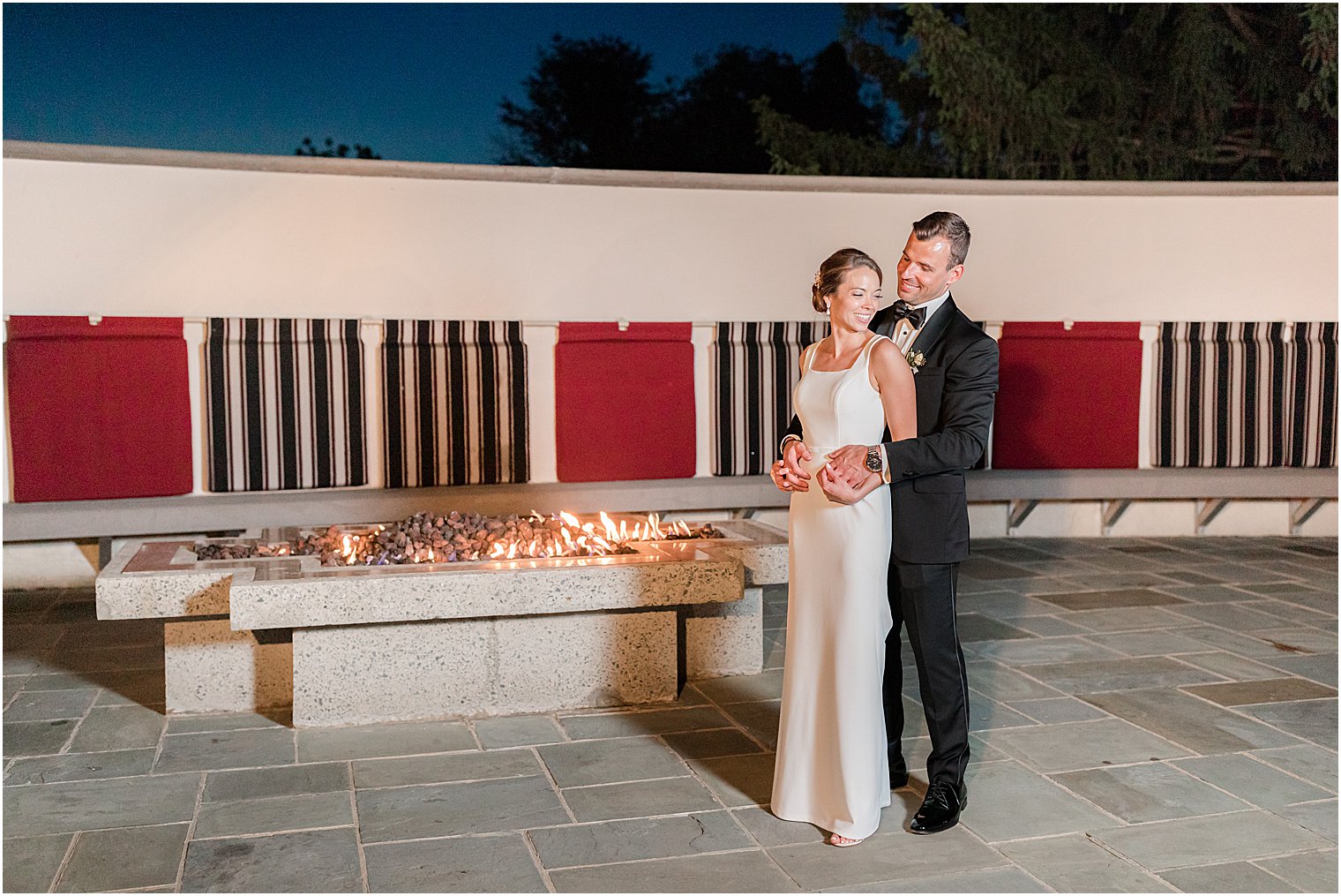 bride and groom pose on patio at Ryland Inn