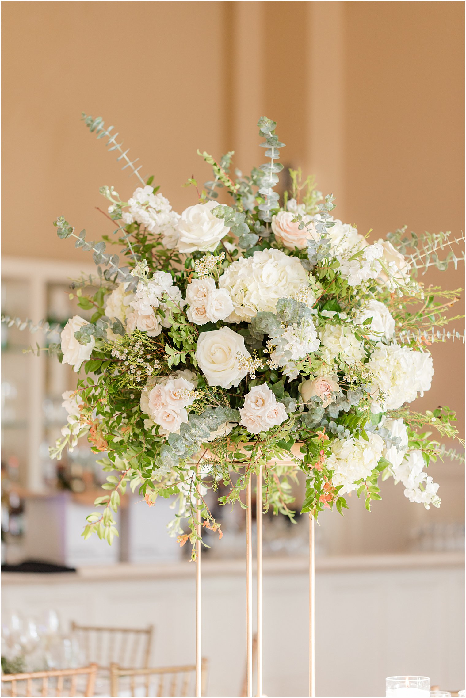 centerpiece with ivory and green floral centerpieces at spring wedding reception at Ryland Inn