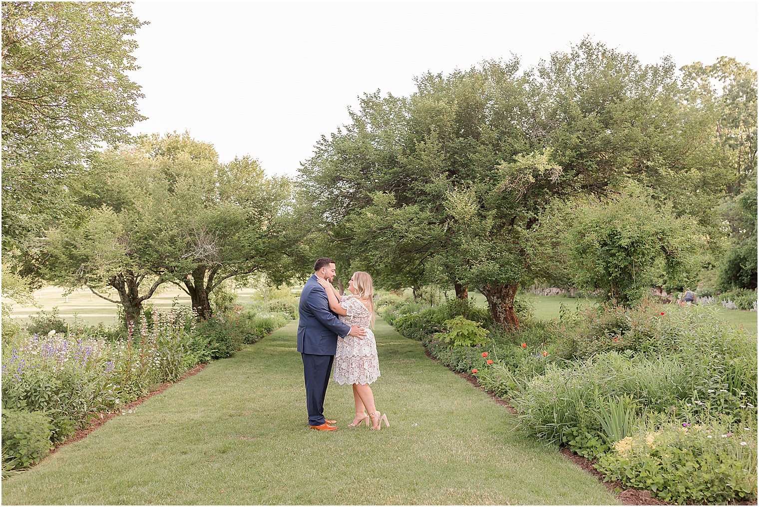 bride and groom hug on lawn at Skylands Manor