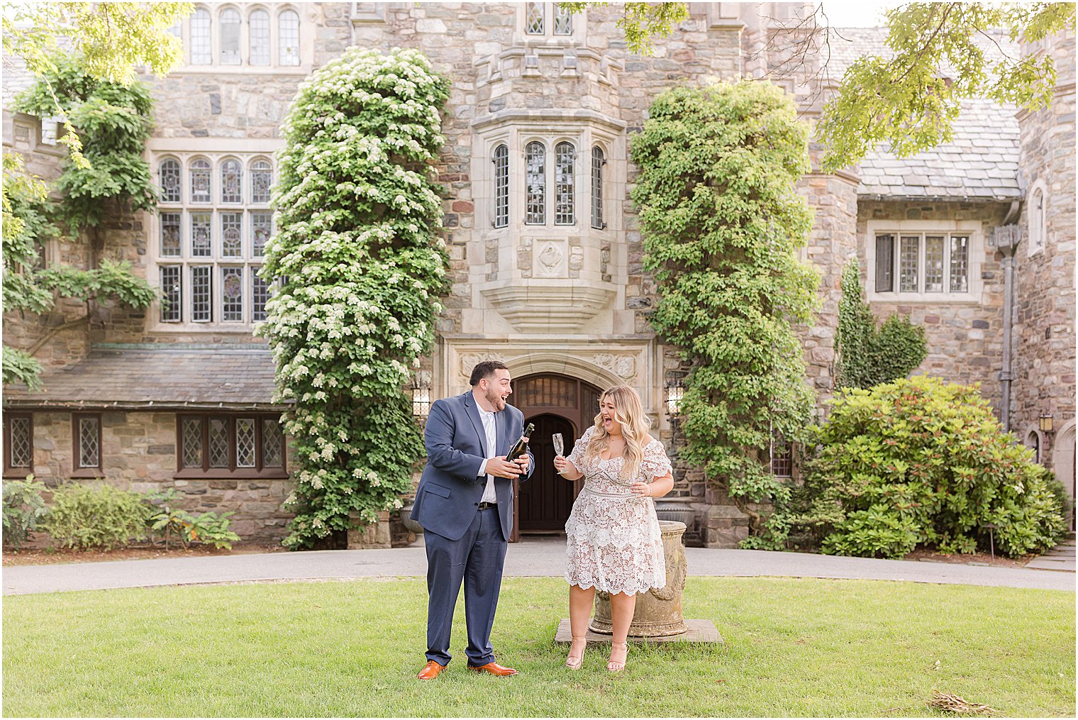 couple holds champagne during Skylands Manor engagement session