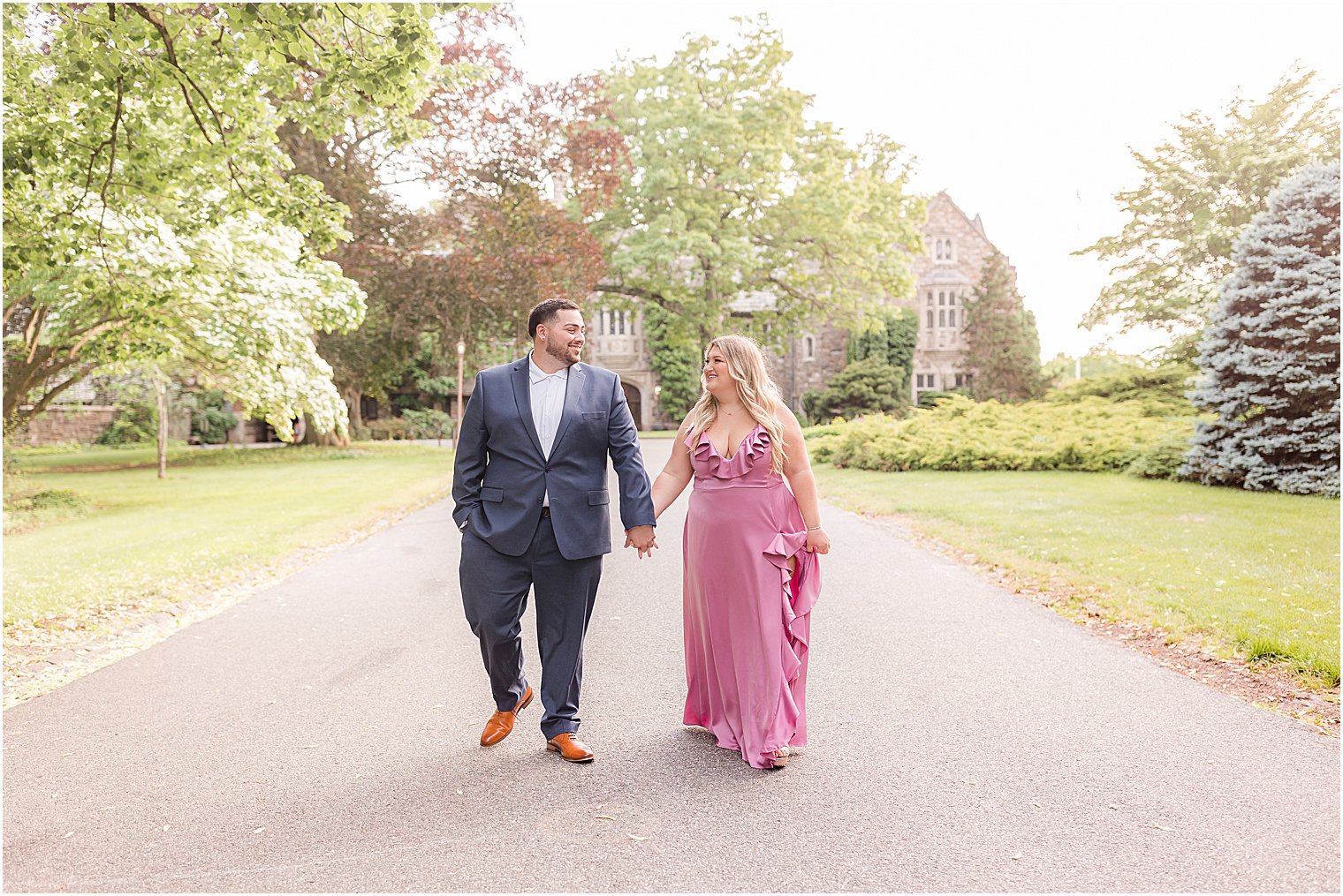 couple holds hands walking through Skylands Manor