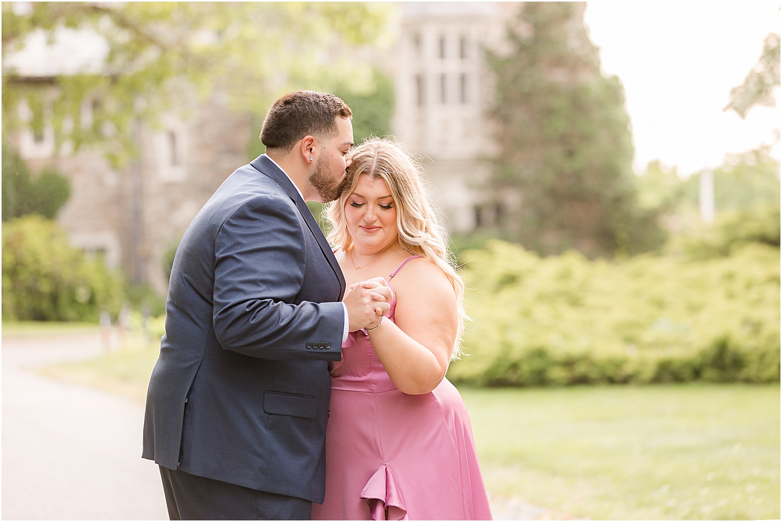 groom leans in for kiss on bride's forehead 