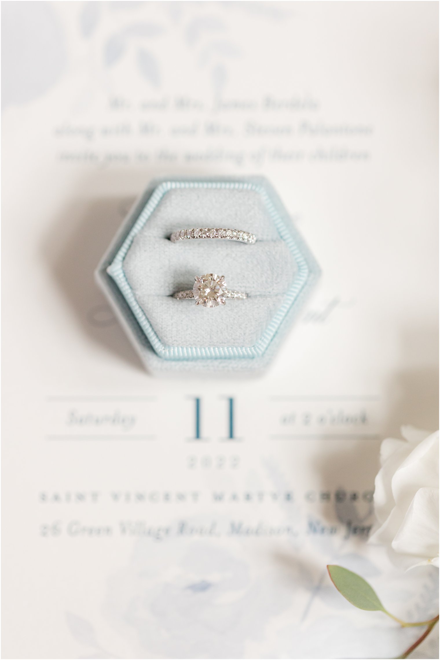 wedding rings rest in light blue box on invitation suite for Spring Brook Country Club wedding