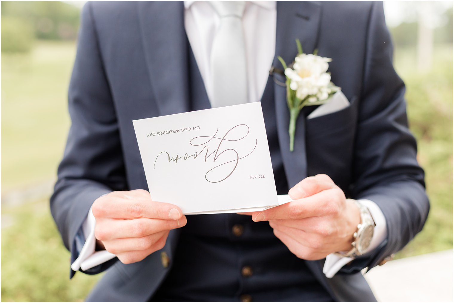 groom opens letter from bride on wedding day