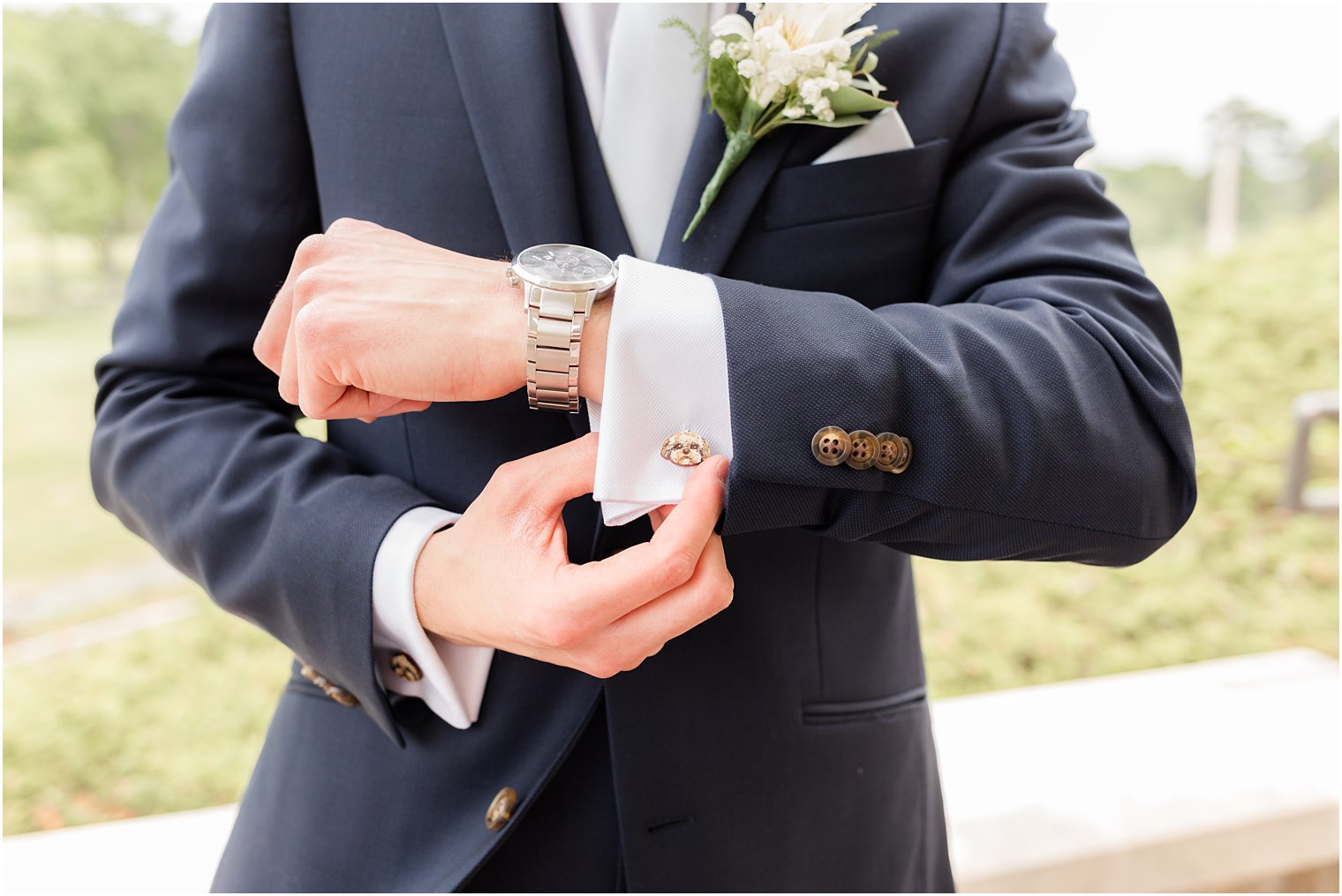 groom adjust cufflinks before Spring Brook Country Club wedding