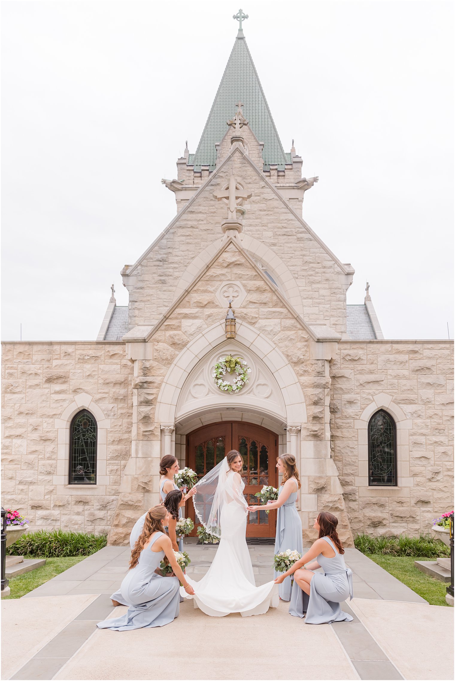 bride prepares for wedding day with bridesmaids outside St. Vincent Martyr Church
