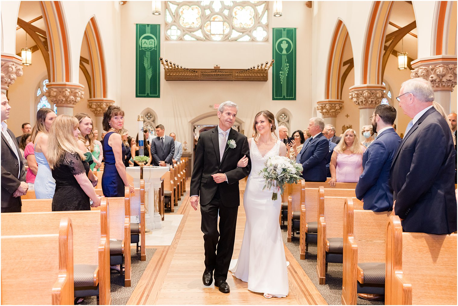 bride and dad walk down aisle for traditional church ceremony at St. Vincent Martyr Church